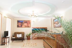 a living room with a ceiling with a chandelier at Health Resort Dolina Narzanov Nalchik in Nalchik