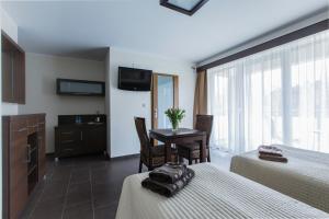 a hotel room with two beds and a table at Villa Nova 34A in Hel
