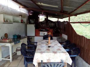 a kitchen with a table and chairs in a room at Bungalows Zdravets in Berkovitsa +21 photos