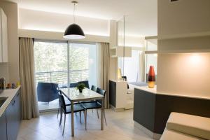 a kitchen and dining room with a table and chairs at Lungotevere Suite in Rome