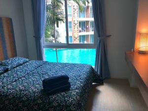 Postel nebo postele na pokoji v ubytování Atlantis Condo Resort jomtien