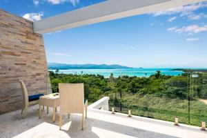 a view of the ocean from the balcony of a house at Sunset Lagoon Villa Rihanna in Bangrak Beach