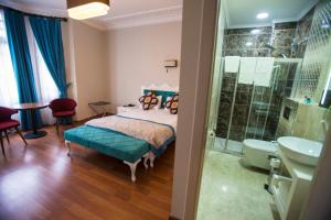 a bedroom with a bed and a shower and a sink at The Void Hotel - Sisli Istanbul in Istanbul