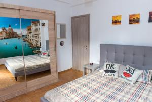 a bedroom with a bed and a mirror at Lianos Apartments Business Class A in Piraeus