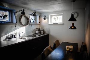 a kitchen with a sink and a table and a window at Vivante Basement Accommodation in Porvoo