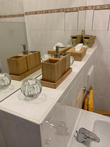 a bathroom with three wooden boxes on a counter at DESIGN Apartment I - 35qm Grenze Altstadt Park in Görlitz