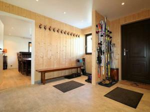 a room with a bench and skis on the wall at Chalet 12 Cerfs in Evolène