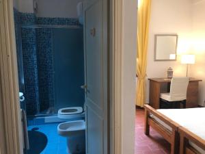 a bathroom with a toilet and a sink at Hotel Palazzo Ducale in Diamante