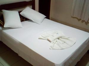 A bed or beds in a room at Pousada Clube Santa Cruz