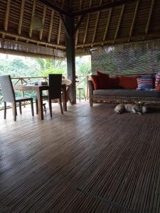 a living room with a couch and a table at Babahan Farmstay in Tabanan