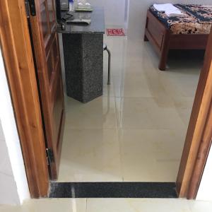 an open door to a kitchen with a tile floor at khách sạn Ngân Hà in Tuy Hoa +5 photos