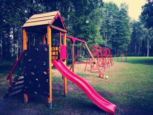 a row of playground equipment in a park at Minhauzena Unda in Saulkrasti