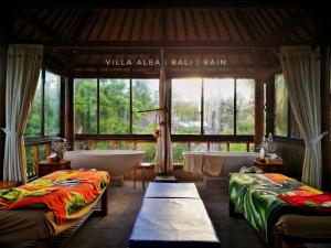A bed or beds in a room at Villa Alba Bali Dive Resort