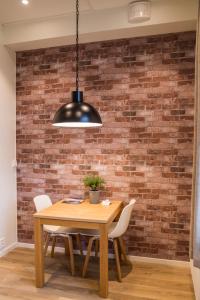 uma mesa de jantar com cadeiras e uma parede de tijolos em Maya Apartments - Thorvald Meyers gt. 38 em Oslo