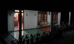 a group of people standing in a house with a pool at Lak Sewana Home Stay in Kandy