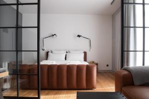 a bedroom with a bed with a glass wall at eswiety10 in Poznań