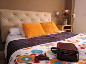 a bed with a bag on top of it at Apartamento Domingo Lozano in Málaga