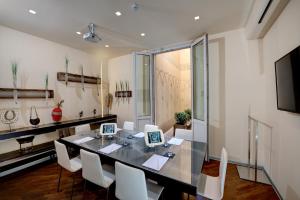 a kitchen with a table, chairs and a microwave at Hotel Metropolitan in Bologna