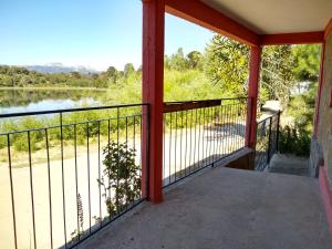 a balcony with a view of a river at Laguna Verde Departamentos in Villa Pehuenia