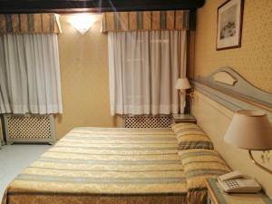 Postel nebo postele na pokoji v ubytování Hotel Falier