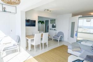 a white living room with a table and chairs at Dreamy Sea View Accommodation Gran Canaria in San Agustin +34 photos