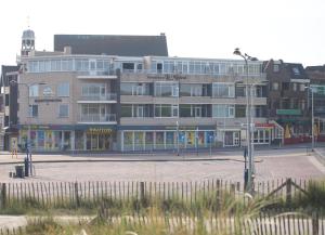 a large building on a street in a city at Residence Le Mistral in Noordwijk aan Zee