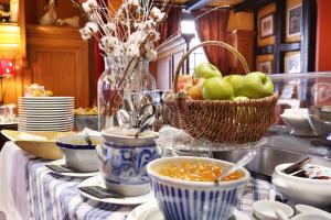 a table with bowls of soup and a basket of apples at Hotel Suisse in Strasbourg