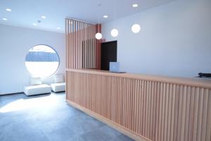 a room with a partition with a television and a mirror at COCORO HOTEL in Kyoto