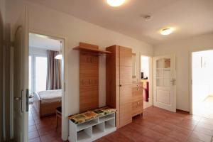 a room with a bedroom with a closet and a bed at Residenz Falkenberg by Rujana in Ostseebad Sellin
