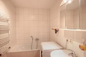 a bathroom with a tub and a toilet and a sink at Residenz Falkenberg by Rujana in Ostseebad Sellin
