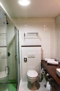 a bathroom with a toilet a sink and a shower at Bonvital Hotel Hévíz Adults Only in Hévíz