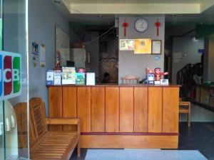 a shop with a counter and a clock on the wall at Golden Myanmar Guest House in Bagan