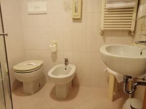 a bathroom with a toilet and a sink at Hotel Falier in Venice