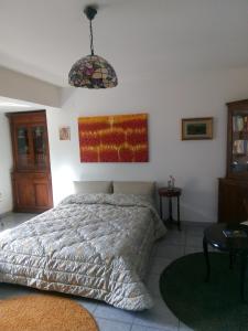 ein Schlafzimmer mit einem Bett und einer Hängeleuchte in der Unterkunft "Al Vecchio Studio" in Vibo Valentia