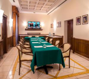 a dining room with a long table and chairs at Lancaster Hotel in Milan