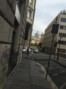 a couple of people walking down a city street at Sofia Holiday Home in Rome