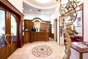 a lobby with a doctor in the background at Lancaster Hotel in Milan