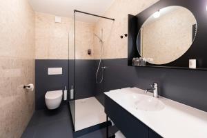 a bathroom with a sink and a shower at Hotel-Restaurant Beim Schlass in Wiltz