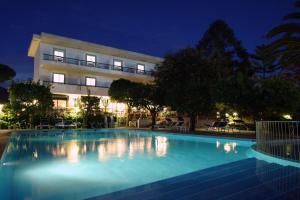 a swimming pool in front of a building at night at Hotel Alpha in Sant'Agnello