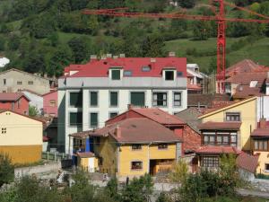 a group of houses in a town with a crane at Apartamento rural Felechosa in Felechosa