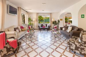 a large living room with couches and tables at Hotel Alpha in Sant'Agnello