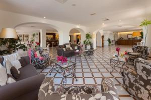 a large living room with couches and tables at Hotel Alpha in Sant'Agnello