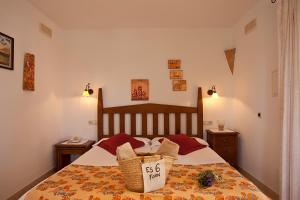a bedroom with a bed with a price sign on it at Agroturisme Na Martina in Portopetro