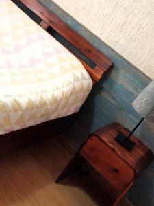 a bed and a wooden table next to a bed at Apto Valentina Salou in Salou +12 photos