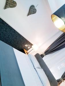 a room with a bed with blue sheets and a light at Apto Valentina Salou in Salou