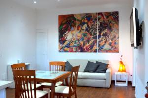 a living room with a table and a couch at Casa di Alberta in Rome