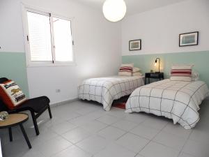 A bed or beds in a room at Apartamentos Medano - Duplex Sea Views