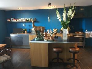 a kitchen with a island with a vase of animals on it at Côté Jardin, Chambres d’hôtes B&B in Le Pont-de-Beauvoisin