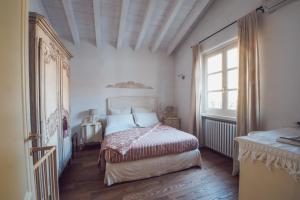 a bedroom with a bed and a large window at La Favola Sirmione in Sirmione