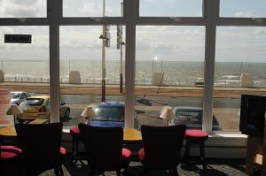 Zimmer mit einem Tisch und Stühlen sowie Meerblick in der Unterkunft Howard Hotel in Blackpool